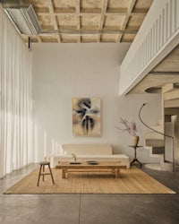a living room with wooden floors and a staircase