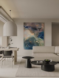 a living room with a large painting on the wall