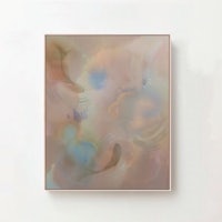 an abstract painting hanging on a wall