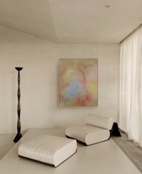 a white room with a painting on the wall