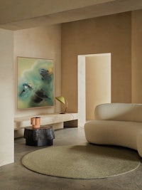 a living room with a large painting on the wall